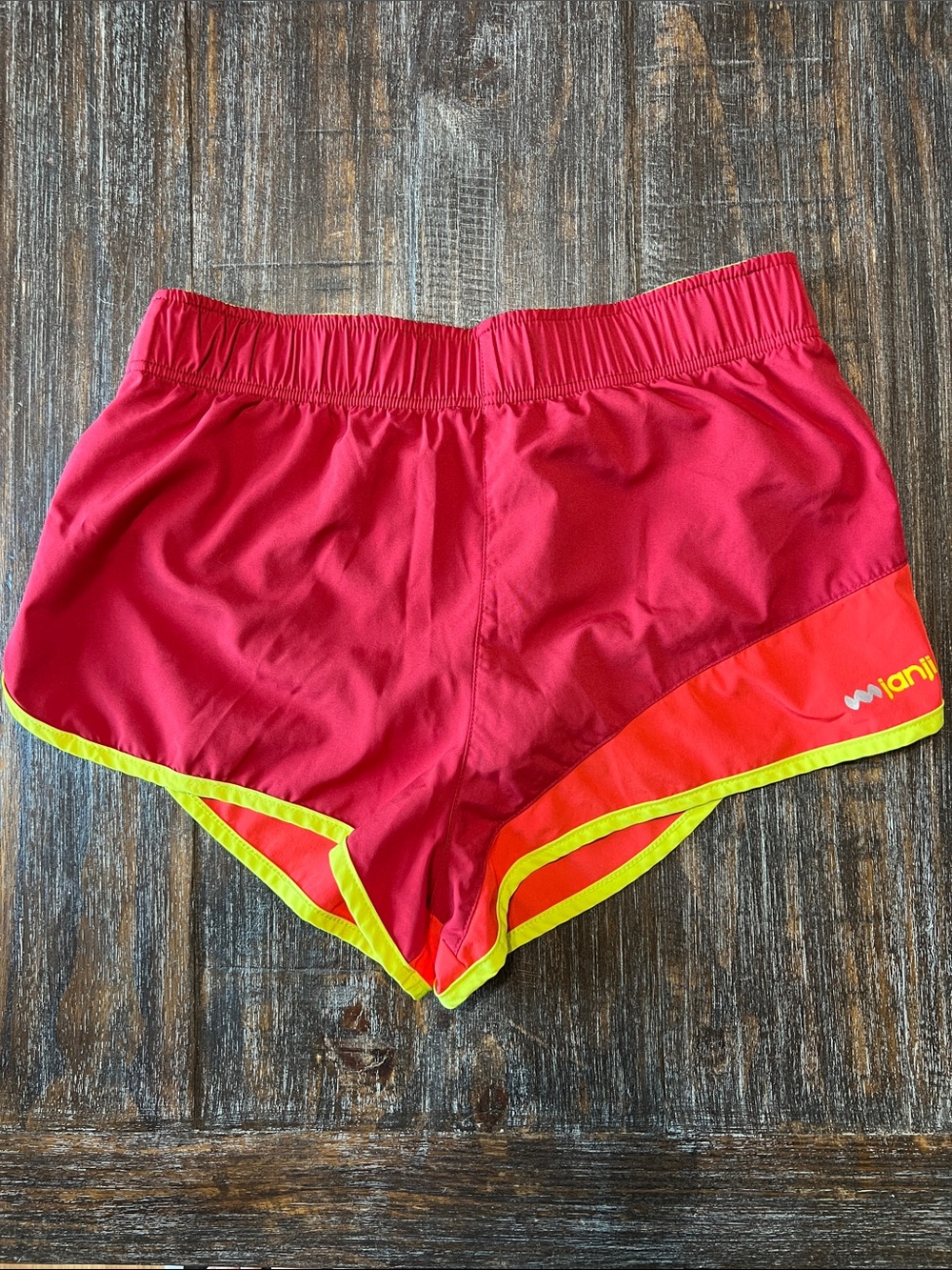 Janji Red Shorts with Neon Yellow Trim and Silver Logo Run For Kenya